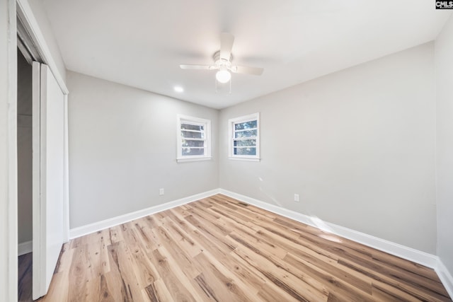 unfurnished bedroom featuring ceiling fan, light wood-type flooring, and a closet