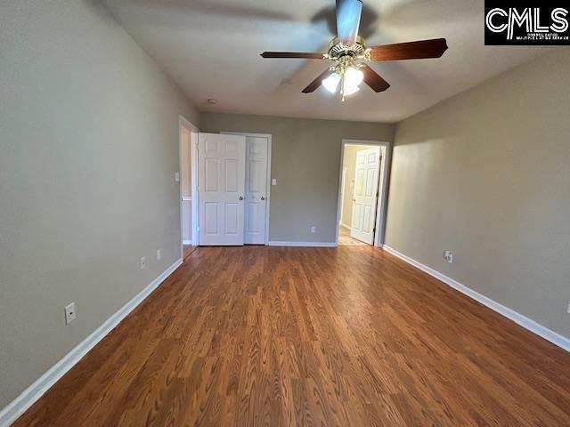 unfurnished bedroom featuring ceiling fan, wood finished floors, and baseboards