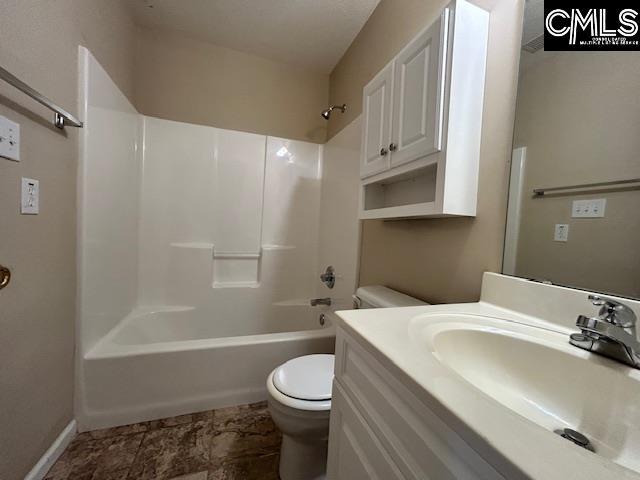 full bathroom featuring baseboards, bathing tub / shower combination, toilet, and vanity