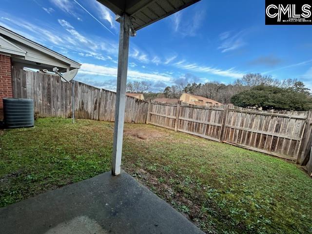 view of yard featuring a fenced backyard, a patio, and central AC