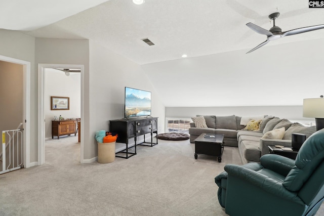 carpeted living room with ceiling fan, vaulted ceiling, and a textured ceiling