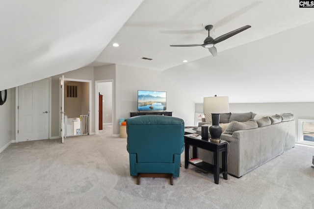 living room with lofted ceiling, ceiling fan, and light carpet