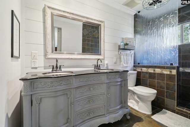 bathroom with toilet, vanity, and tile patterned flooring