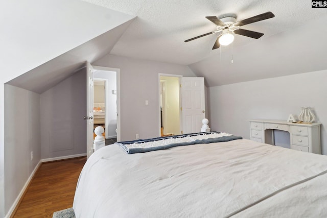 bedroom featuring ceiling fan, vaulted ceiling, a textured ceiling, and hardwood / wood-style floors