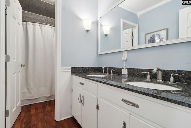 bathroom with ornamental molding, walk in shower, hardwood / wood-style floors, and vanity