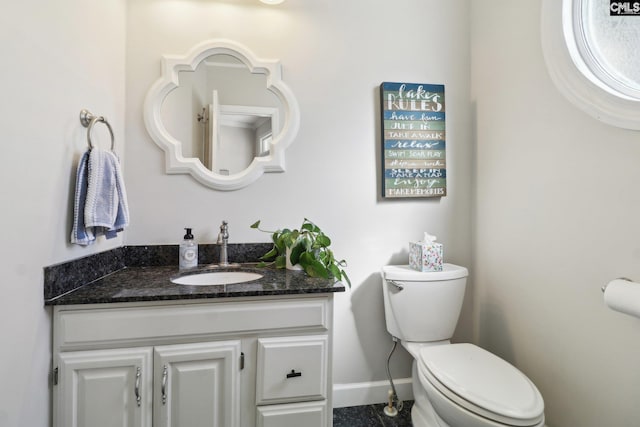 bathroom featuring toilet and vanity