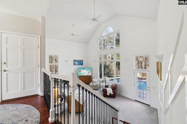 entrance foyer with high vaulted ceiling, ceiling fan, and dark hardwood / wood-style flooring