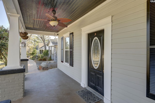 doorway to property with ceiling fan and a porch