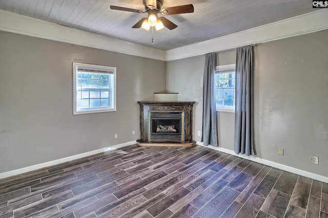 unfurnished living room featuring ceiling fan and dark wood-type flooring