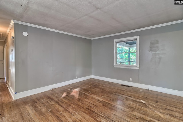 spare room featuring wood-type flooring, a textured ceiling, and ornamental molding