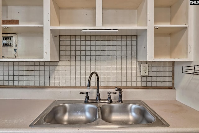 kitchen featuring sink and tasteful backsplash