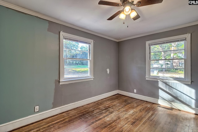 unfurnished room featuring ceiling fan, a wealth of natural light, ornamental molding, and hardwood / wood-style flooring