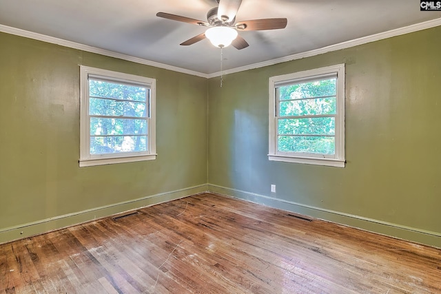 empty room featuring ceiling fan, ornamental molding, and hardwood / wood-style flooring