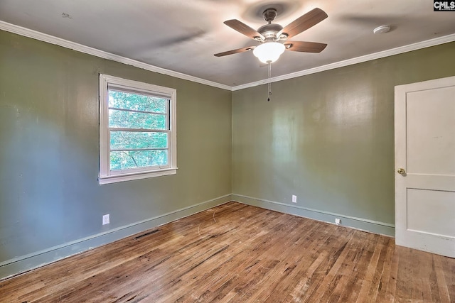 spare room with ceiling fan, ornamental molding, and hardwood / wood-style flooring