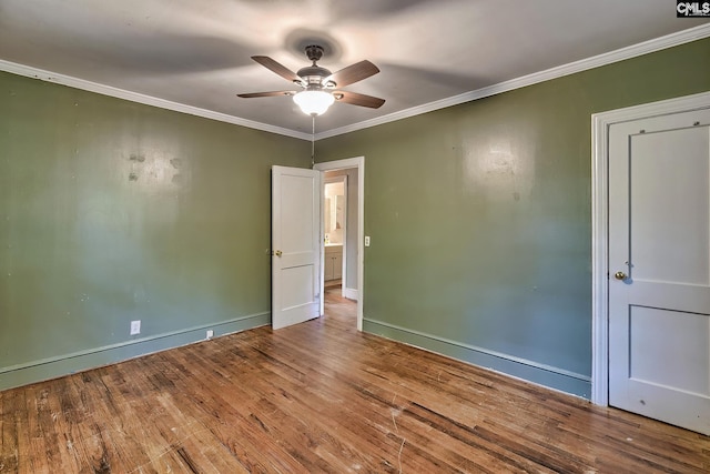 spare room with ceiling fan, crown molding, and hardwood / wood-style flooring