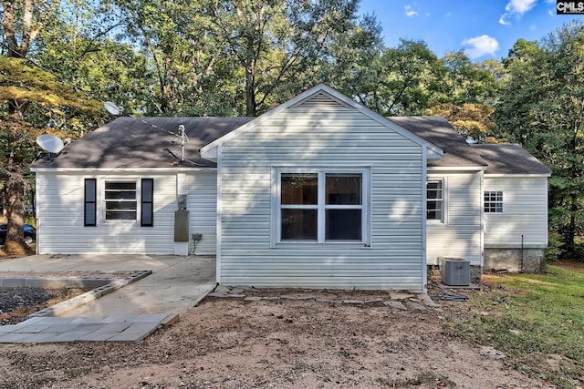 back of property with cooling unit and a patio