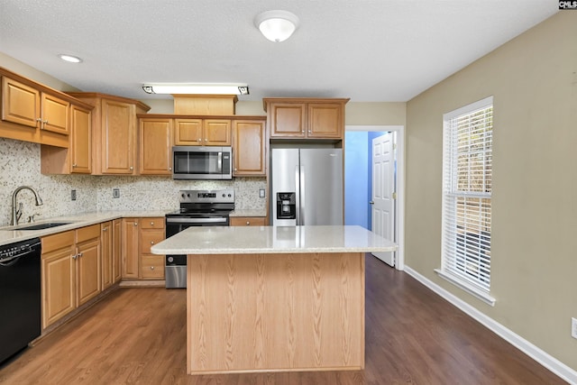 kitchen featuring stainless steel appliances, tasteful backsplash, dark hardwood / wood-style flooring, a kitchen island, and sink