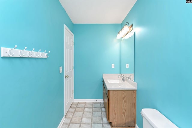 bathroom with toilet and vanity