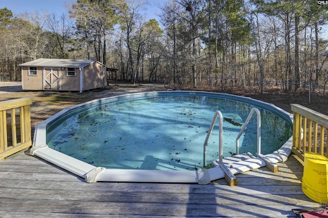 view of pool featuring a deck and a storage unit