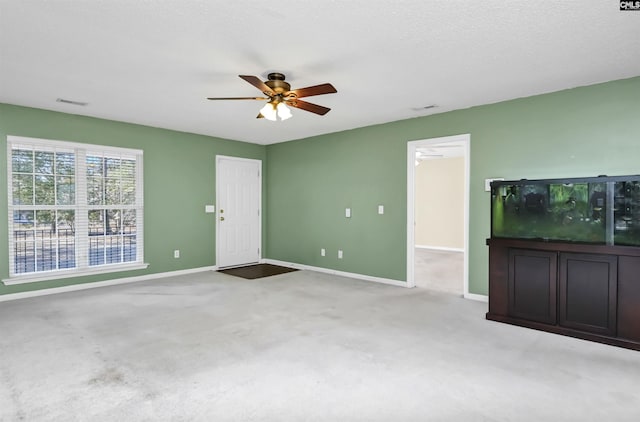 unfurnished living room with ceiling fan and light colored carpet