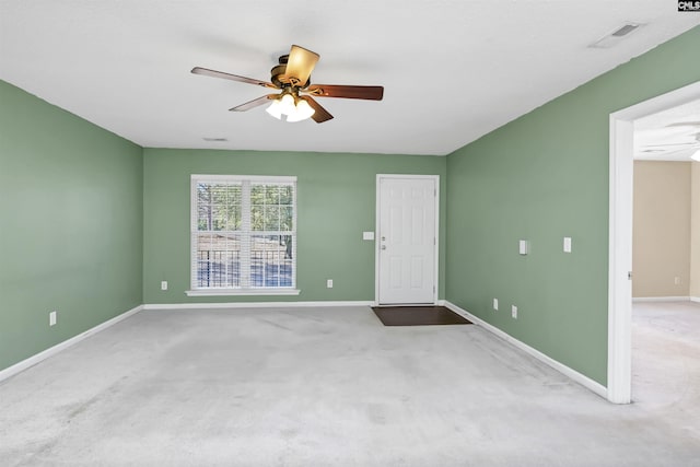 spare room featuring ceiling fan and light colored carpet