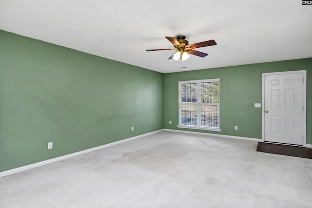 unfurnished room featuring ceiling fan and light carpet