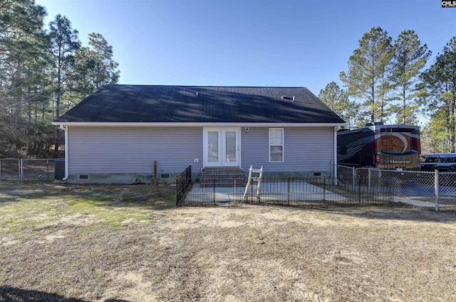 back of property with a patio area, a lawn, and french doors