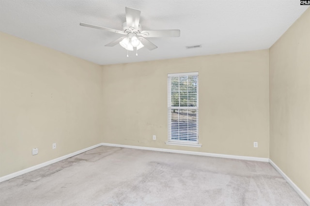 empty room with ceiling fan and light colored carpet