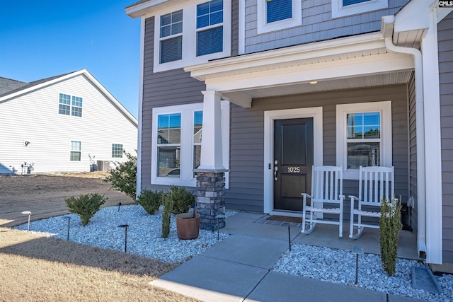 view of exterior entry with covered porch