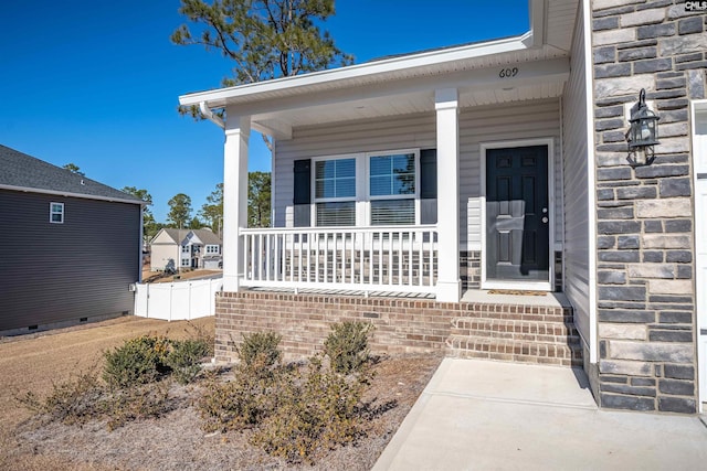 view of exterior entry featuring a porch