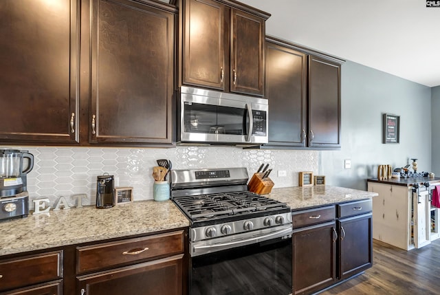 kitchen with light stone counters, appliances with stainless steel finishes, tasteful backsplash, and dark brown cabinetry