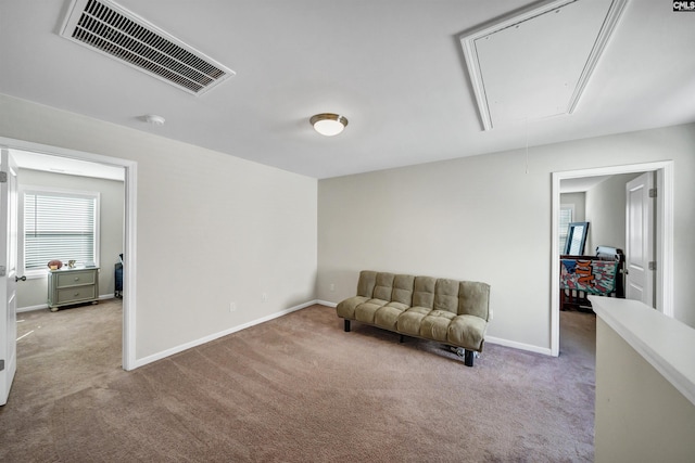 sitting room featuring light colored carpet