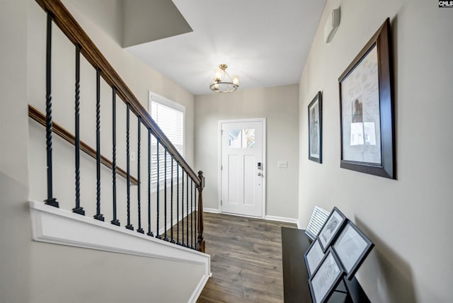 entrance foyer featuring dark hardwood / wood-style floors and an inviting chandelier