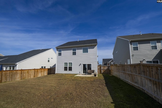 rear view of property with a lawn and a patio area