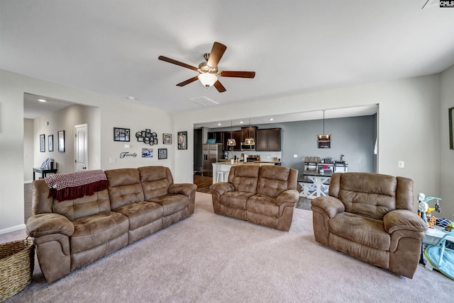 carpeted living room featuring ceiling fan