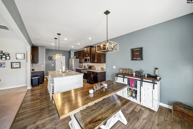 dining area featuring dark hardwood / wood-style floors and sink