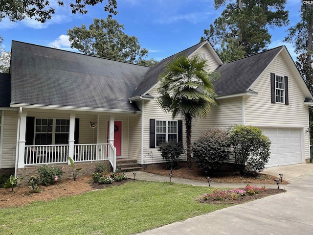 view of front of home with a garage, a front yard, and a porch