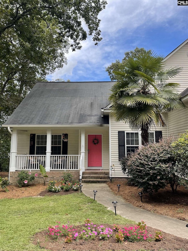 view of front of home with covered porch and a front yard