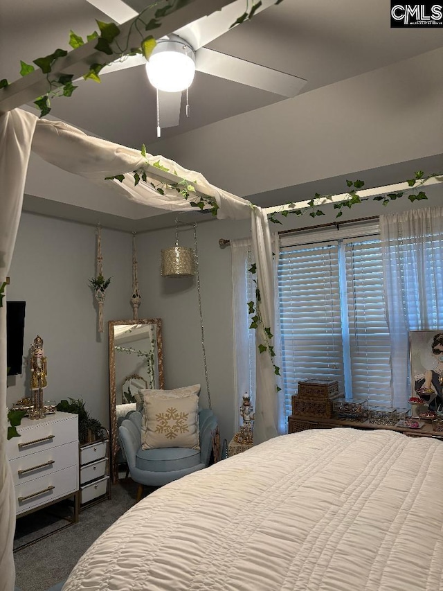 bedroom with ceiling fan and dark carpet