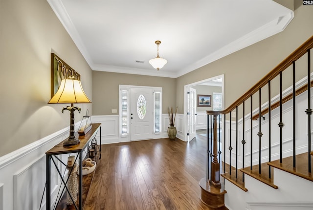 foyer featuring dark hardwood / wood-style floors and ornamental molding