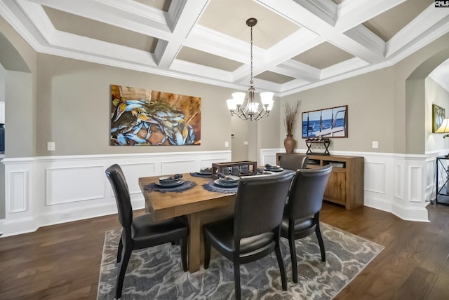 dining area with beamed ceiling, coffered ceiling, dark wood-type flooring, ornamental molding, and a chandelier