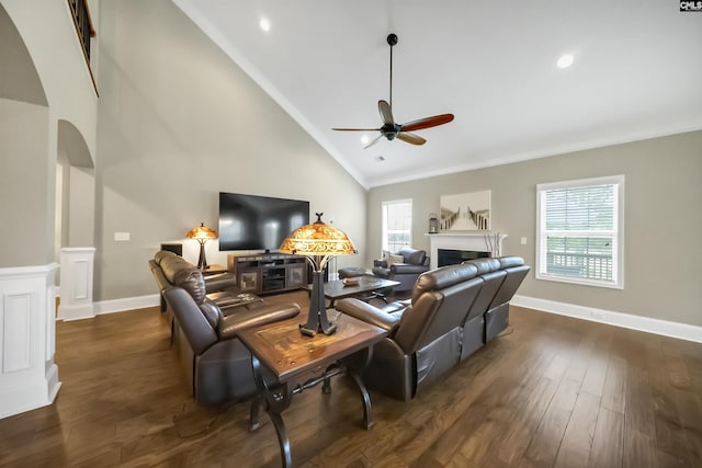 living room featuring ceiling fan, dark wood-type flooring, a wealth of natural light, and high vaulted ceiling