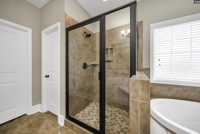 bathroom with independent shower and bath and tile patterned floors