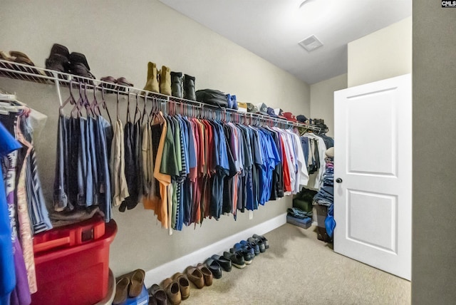 walk in closet featuring carpet floors