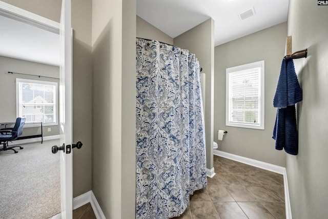 bathroom with tile patterned floors and toilet