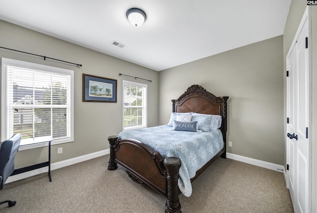 carpeted bedroom featuring multiple windows