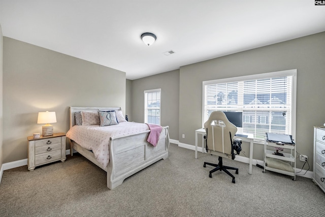 bedroom featuring multiple windows and carpet flooring