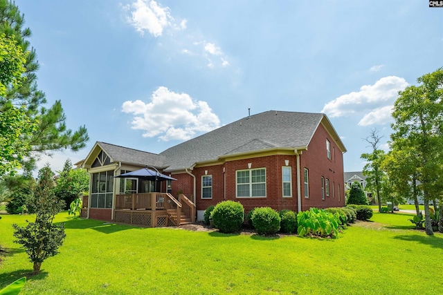 rear view of house featuring a deck, a gazebo, and a lawn