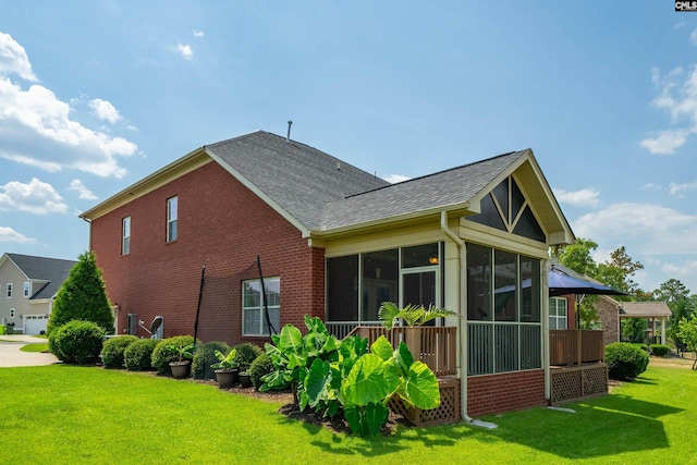 view of property exterior with a sunroom and a yard