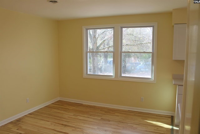 spare room with light hardwood / wood-style flooring